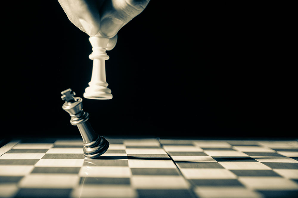 Two chess pieces facing each other on a chess board